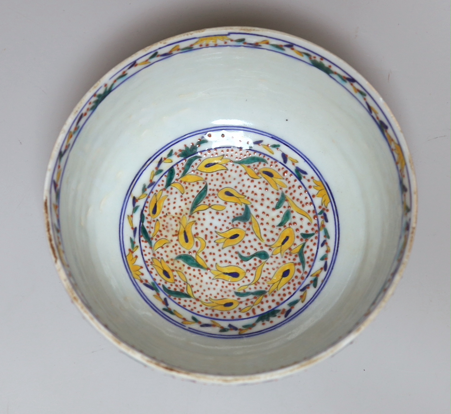 A Turkish Kutahya bowl hand painted with stylised flowers, 19cm in diameter